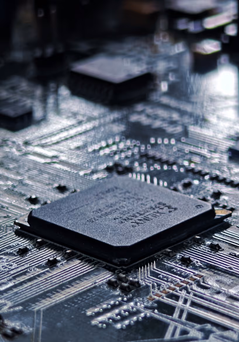 Close-up view of a computer microchip mounted on a circuit board with surrounding electronic components.